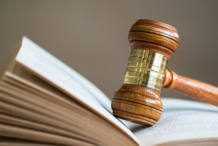Law theme, mallet of the judge, wooden desk, books