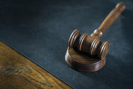 brown gavel on the table on a brown background