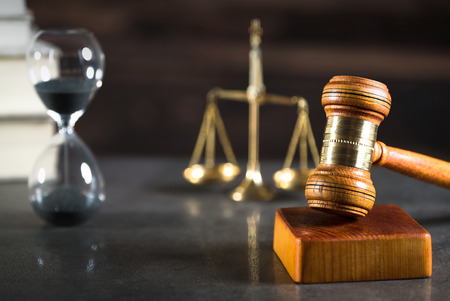 Law and Justice concept with gavel and scale in background. Composition in court