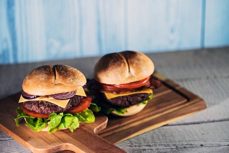 fresh tasty burger on wood tableの写真素材