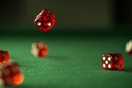 Casino theme. High contrast image of casino roulette, poker game, dice game, poker chips on a gaming...