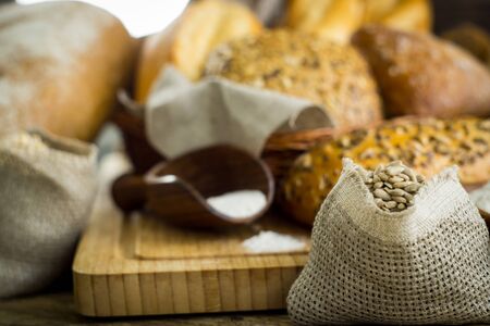 Variety of bread on old wooden table