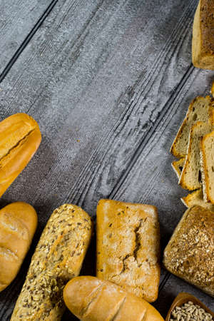 Variety of bread on old wooden tableの写真素材