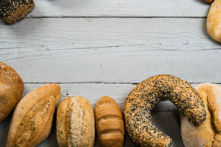 Variety of bread on old wooden table