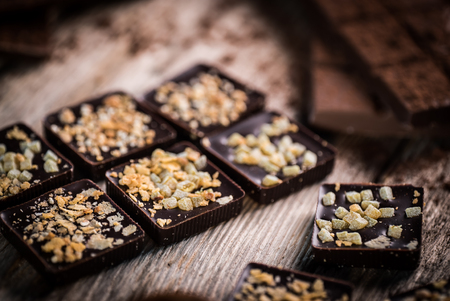 home made chocolate bar and spices on wooden tableの写真素材