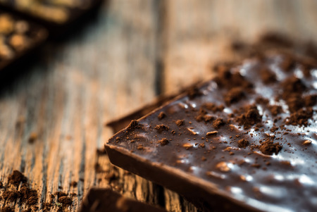 home made chocolate bar and spices on wooden tableの写真素材