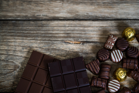 Broken chocolate bar and spices on wooden table. Selective focusの写真素材