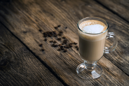 Coffee and coffee beans on wooden backgroundの写真素材