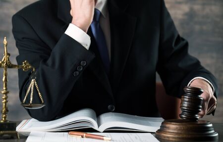 Gavel on wooden table and Lawyer or Judge with lawyer. Courtroom theme, Justice and Law concept.の写真素材