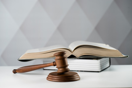 Judge hammer, scales of justice and law books in court