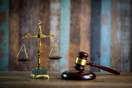 Judges gavel on wooden table with law books. retro style.