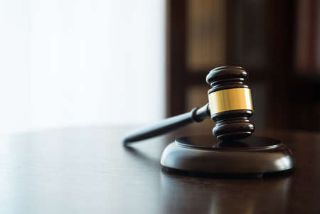 Law and Justice concept. Mallet of the judge, books, scales of justice. Courtroom theme.