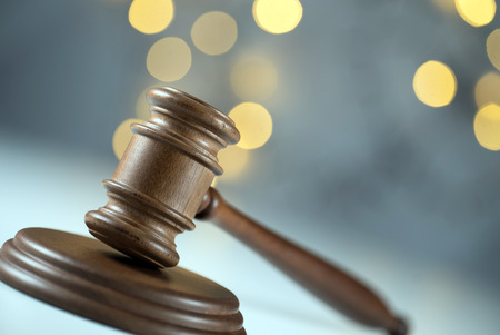 Law theme, mallet of the judge, golden bokeh backgroundの写真素材