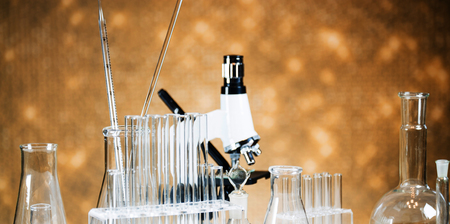 Microscope with lab glassware, science laboratory research concept