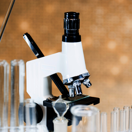 Microscope with lab glassware, science laboratory research conceptの写真素材