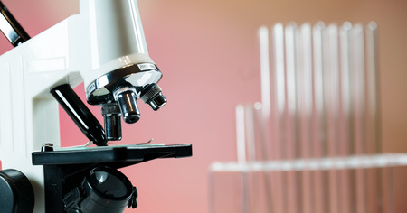 Microscope with lab glassware, science laboratory research concept