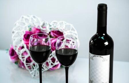 Red wine with flowers in the backの写真素材