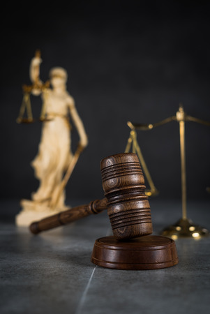 Law and Justice concept. Mallet of the judge, books, scales of justice. Gray stone background, Courtroom theme.の写真素材