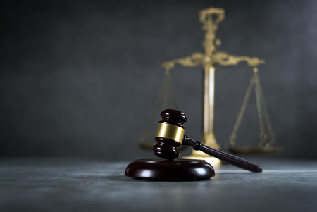 Law and Justice concept. Mallet of the judge, books, scales of justice. Gray stone background, Courtroom theme.の写真素材