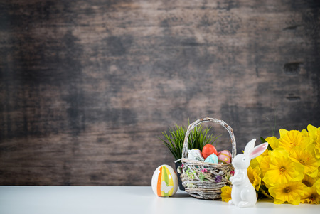 Delicious chocolate easter eggs, bunny and sweets on dark wood backgroundの写真素材