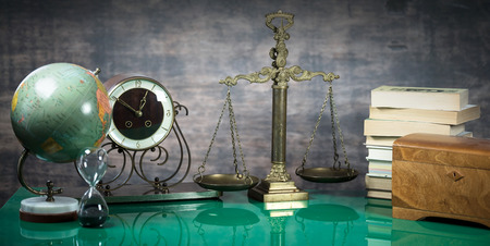 Law and Justice concept. Gavel of the judge, books, scales of justice. Brown background, Courtroom theme.の写真素材