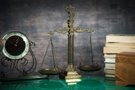 Law and Justice concept. Gavel of the judge, books, scales of justice. Brown background, Courtroom theme.の写真素材