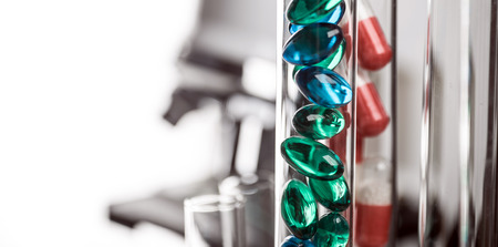 Laboratory Microscope, pills and test tubes. Scientific and healthcare research background.の写真素材
