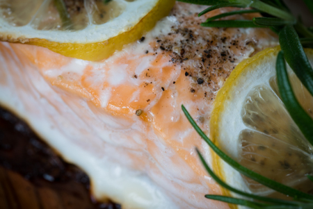 Grilled salmon on grill closeup with lemonの写真素材