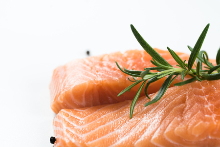 Slices of the fresh salmon on whiteの写真素材