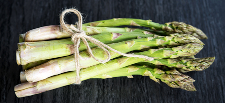 Fresh green asparagus on a stone worktopの写真素材