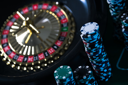 Casino background, poker Chips on gaming table, roulette wheel in motionの写真素材