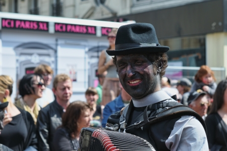 BRUSSELS, BELGIUM-MAY 19: An unknown participant with colored face plays music during Zinneke Parade...