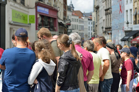 BRUSSELS, BELGIUM-AUGUST 09, 2014  Group of foreign tourists listens to their guide in historical center of Brusselsのeditorial素材