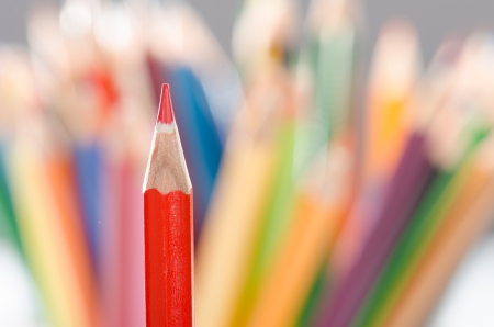 Single red pencil against color pencils background  macroの写真素材