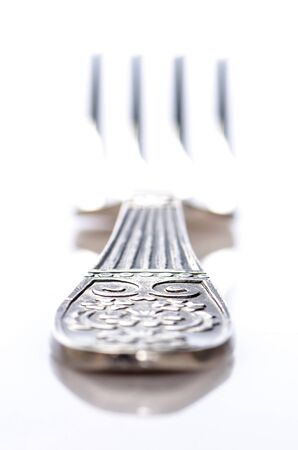 Silver fork against a white backgroundの写真素材