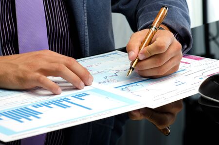 Man's hands working on business reports at the office