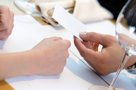 Hand giving business card during business lunch
の写真素材