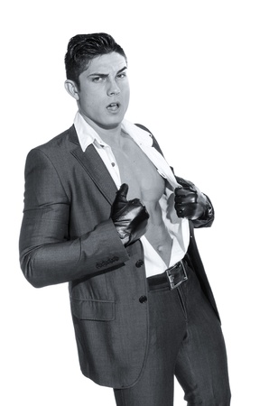 Portrait of young muscular man unbuttoned his shirt against white backgroundの写真素材