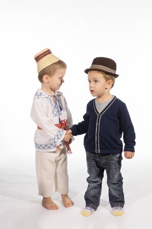 Two children dressed different. One child folk costume dressed  and other casual dressed
の写真素材