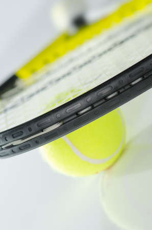 Tennis ball and racket against a white backgroundの写真素材