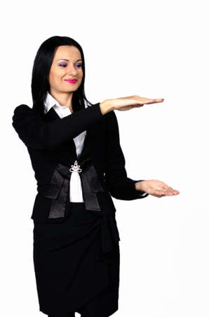 Beautiful brunette looking at your product against white backgroundの写真素材