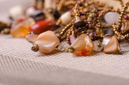 Handmade jewellery presented on a stoneの写真素材