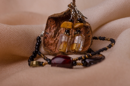 Handmade jewellery bracelet  and earings  presented on a textile surfaceの写真素材