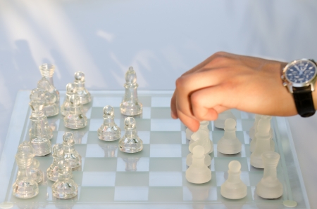 Man hand moving a chess piece