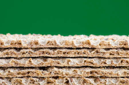 Flattened oatmeal against green backgroundの写真素材