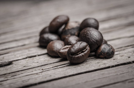 Coffee beans presented on wooden surfaceの写真素材