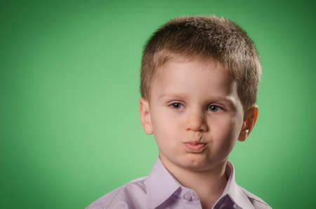 Portrait of child being upset against green background
の写真素材