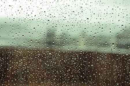 Rain drops on a window, seeiing a fieldの写真素材