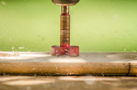 Tool cutting holes in woodの写真素材