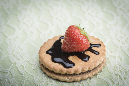 Strawberry and biscuits against a light green backgroundの写真素材